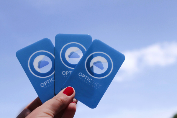 Photo of plastic business cards held against the sky - see through and opaque elements