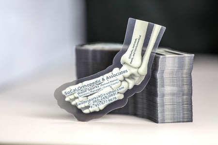 Example of a custom shaped business card printed for SoCal Orthopedic & Associates, excellent example of Medical Marketing.