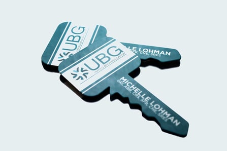 Unique die cut business cards shaped like a key for United Brokers Group