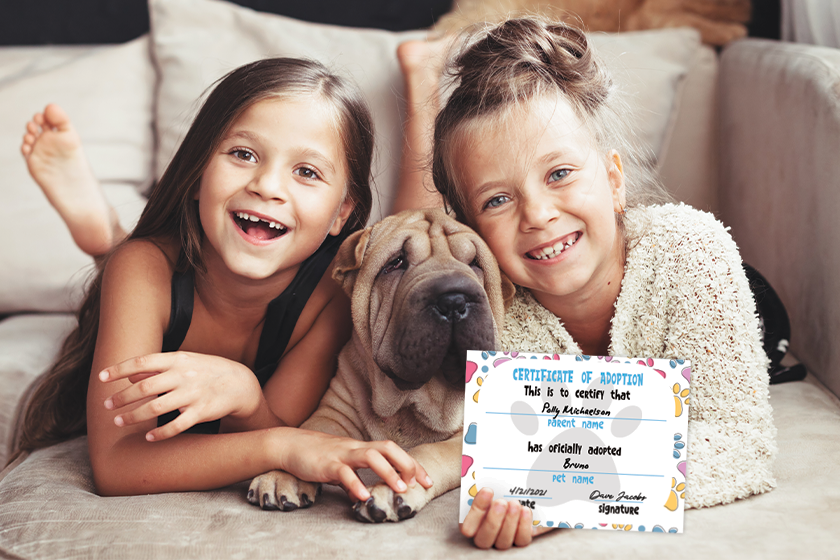 Two girls and a puppy with a pet certificate